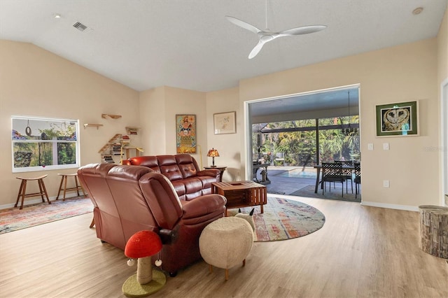 living area with a ceiling fan, lofted ceiling, baseboards, and wood finished floors