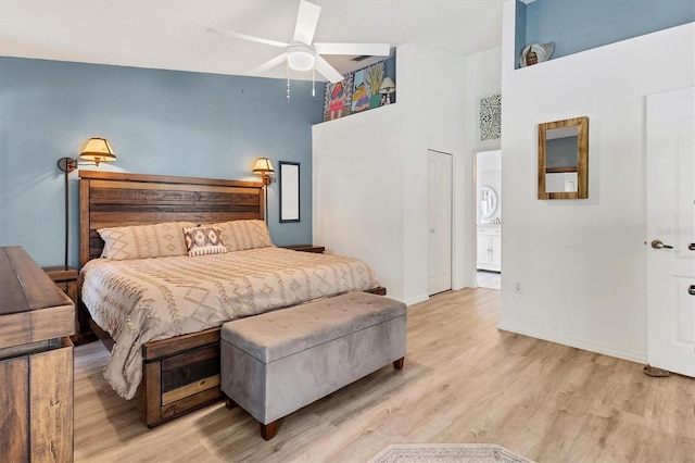 bedroom with a ceiling fan, light wood-style flooring, and baseboards