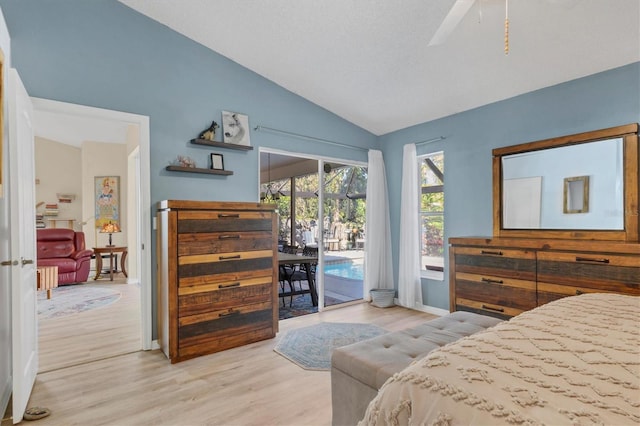 bedroom featuring light wood finished floors, baseboards, a ceiling fan, lofted ceiling, and access to outside