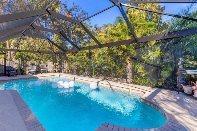 outdoor pool with a lanai and a patio area