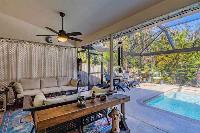 sunroom / solarium featuring ceiling fan