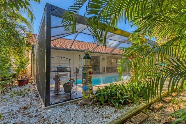 pool with glass enclosure and a patio