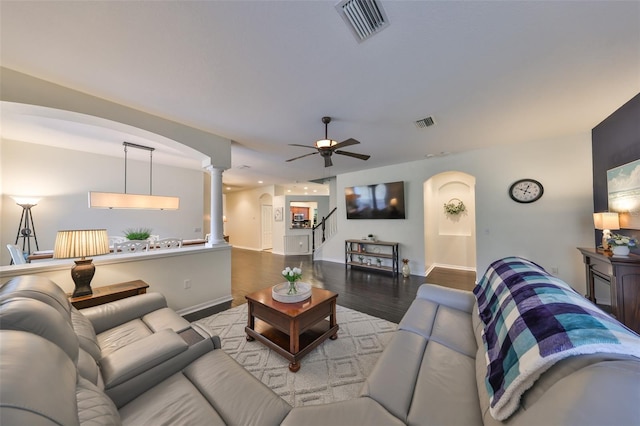 living room with hardwood / wood-style floors, decorative columns, and ceiling fan