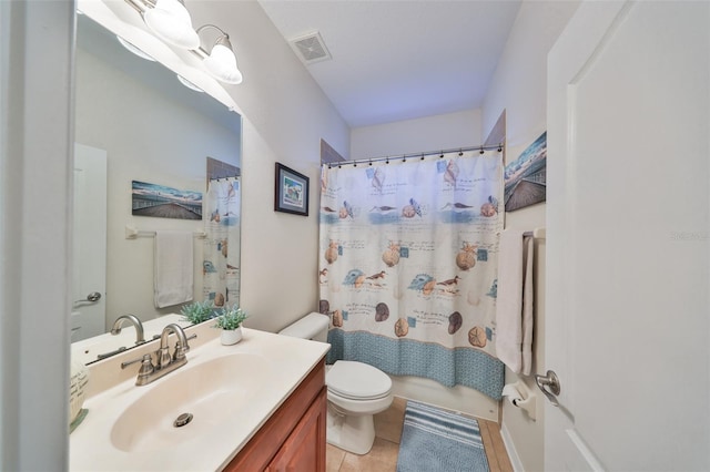 bathroom featuring vanity, tile patterned floors, and toilet