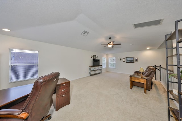 carpeted office featuring ceiling fan, lofted ceiling, and a textured ceiling