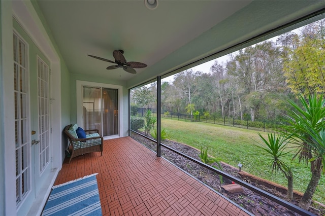 unfurnished sunroom featuring french doors and ceiling fan