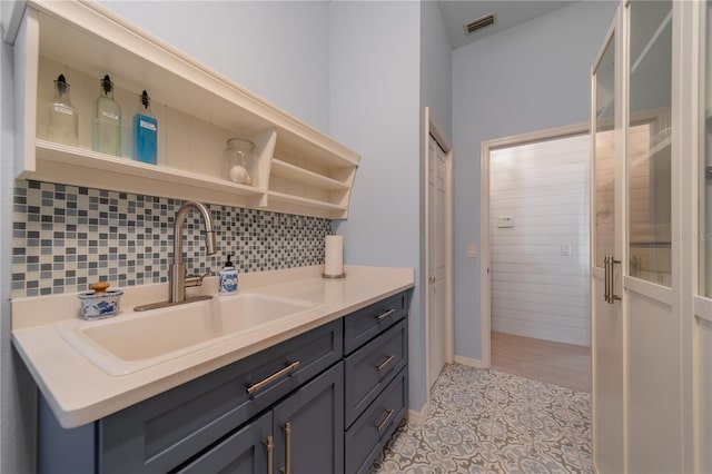 bathroom featuring vanity and backsplash