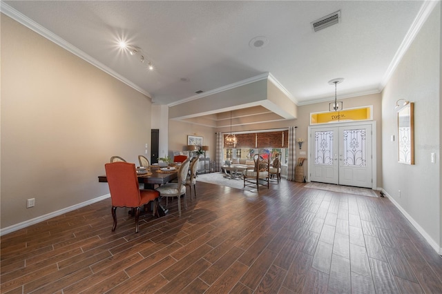 dining room featuring dark hardwood / wood-style floors, ornamental molding, and french doors