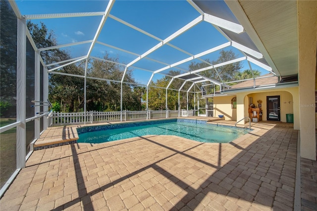 view of pool with a patio and glass enclosure