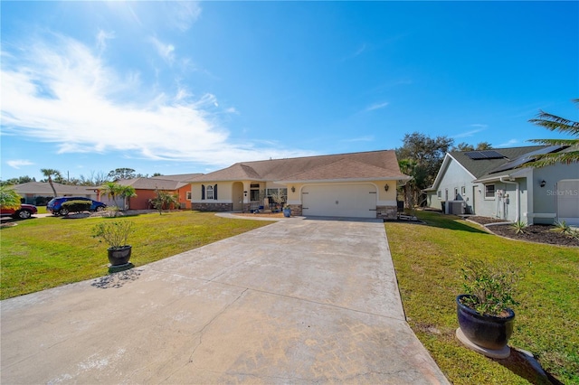 single story home featuring a garage, a front lawn, and solar panels