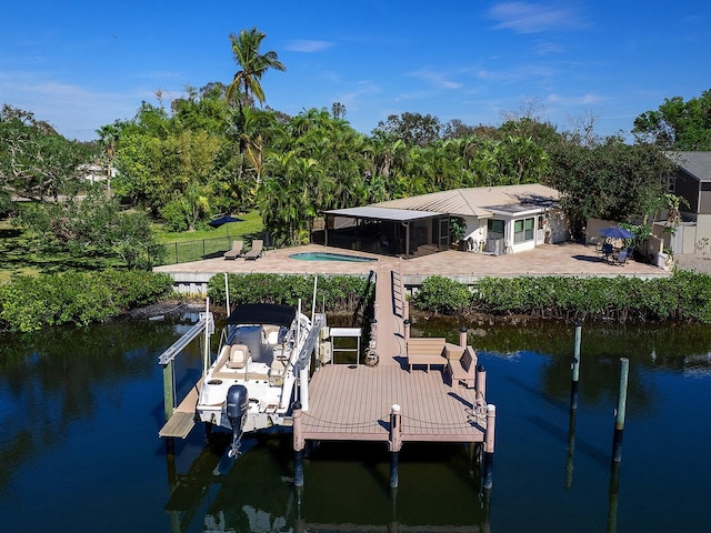 view of dock with a water view and a patio area