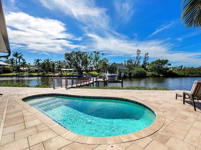 view of pool with a water view and a patio area