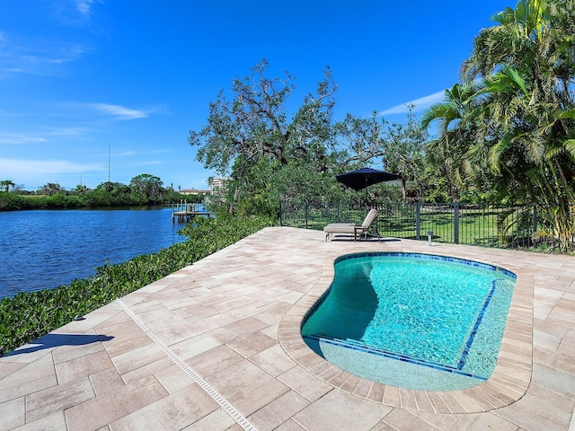 view of swimming pool with a patio and a water view