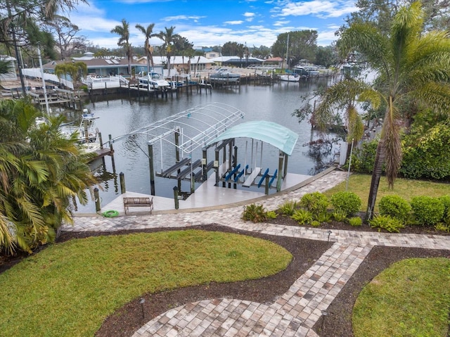 view of dock featuring a water view and a yard