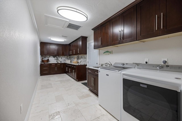 washroom featuring sink, cabinets, and washer and dryer