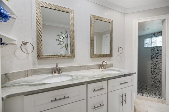 bathroom with crown molding, tiled shower, and vanity