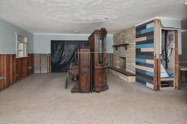 interior space with a fireplace, wooden walls, and a textured ceiling