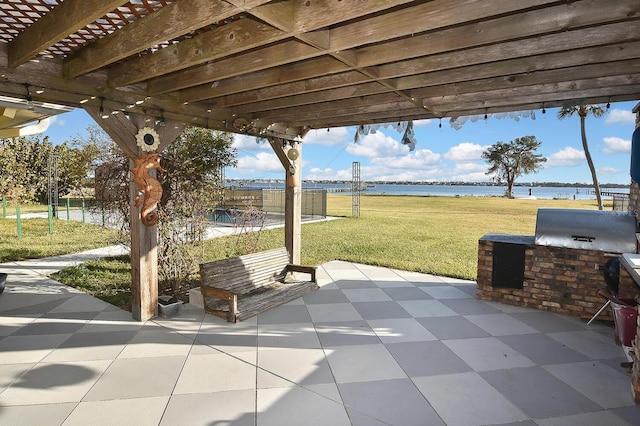 view of patio featuring a water view, an outdoor kitchen, and a pergola