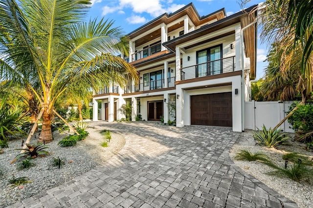 107 Maple Ave, Anna Maria, FL 34216 - view of front facade featuring a balcony and a garage