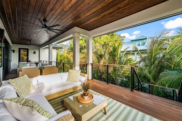 deck with outdoor lounge area and ceiling fan