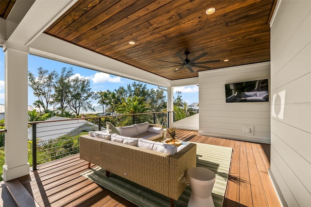 wooden deck featuring an outdoor hangout area and ceiling fan