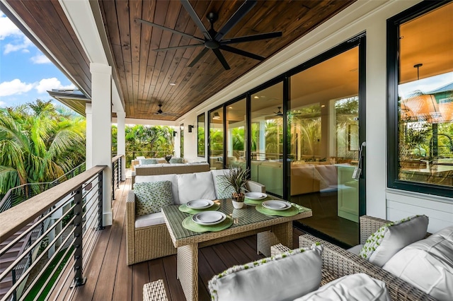 wooden deck featuring ceiling fan and outdoor lounge area