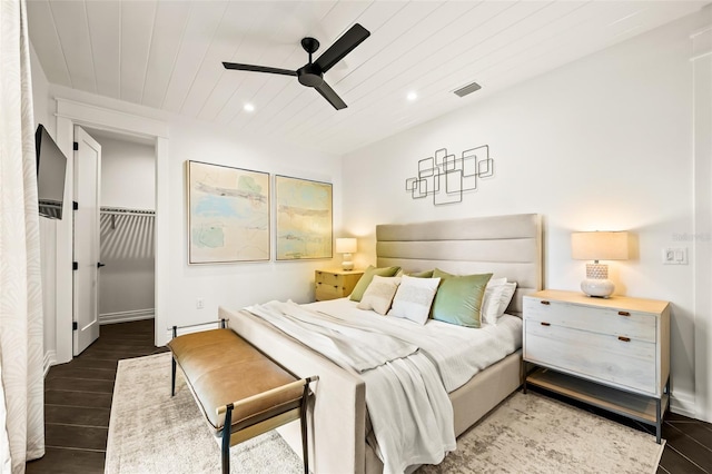 bedroom with wood ceiling, ceiling fan, dark hardwood / wood-style flooring, a spacious closet, and a closet