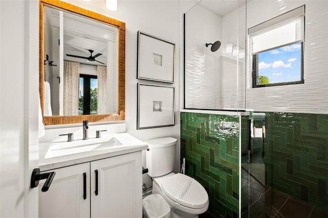 bathroom featuring vanity, tiled shower, and toilet