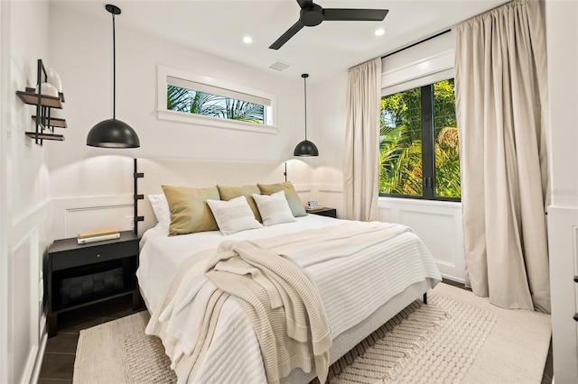 bedroom featuring multiple windows and ceiling fan