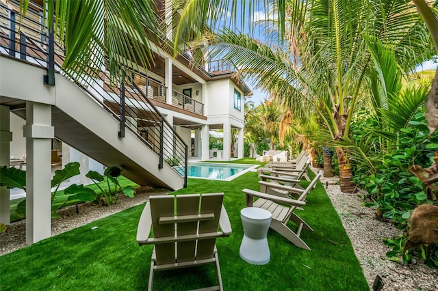 view of home's community featuring a patio area, a swimming pool, and a lawn