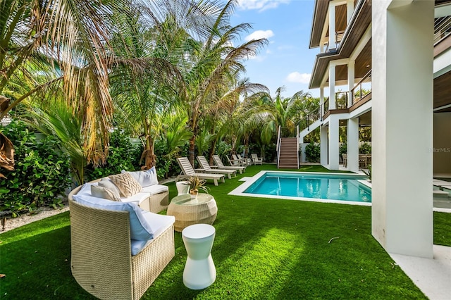 view of swimming pool with an outdoor hangout area and a lawn