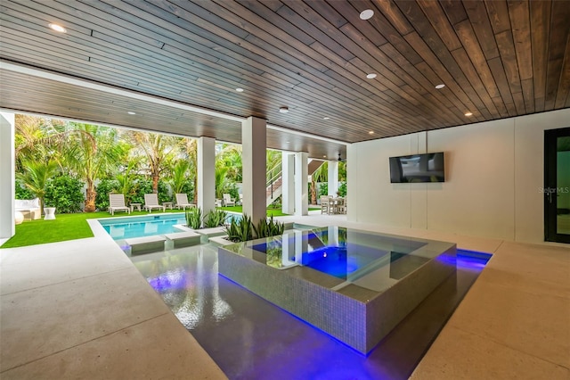 view of swimming pool with a patio area and an in ground hot tub