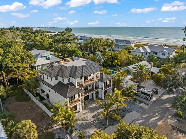 bird's eye view featuring a view of the beach and a water view