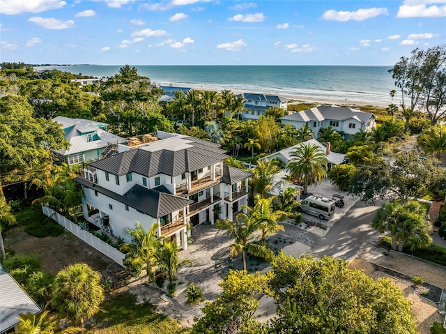 drone / aerial view with a water view and a beach view