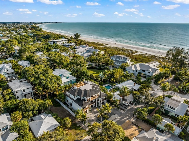 drone / aerial view with a water view and a beach view