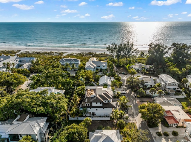 birds eye view of property featuring a view of the beach and a water view