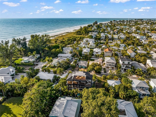 drone / aerial view featuring a water view and a beach view