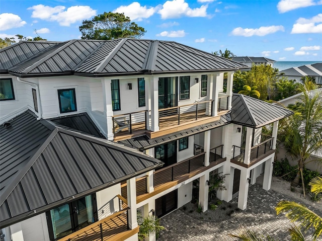 rear view of house with a garage and a balcony