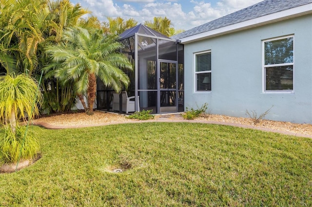 view of yard with glass enclosure