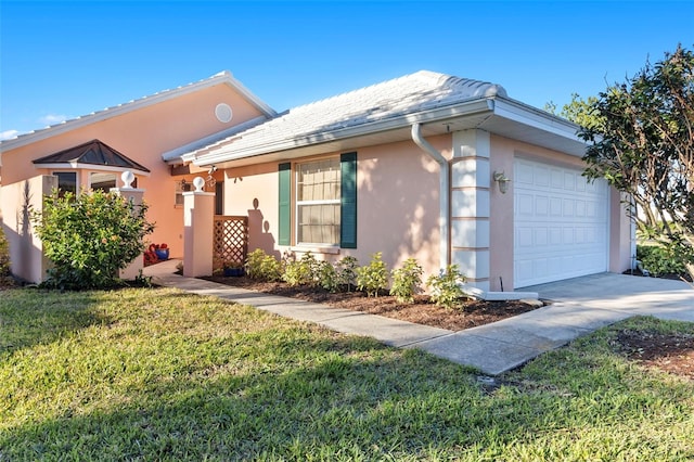 ranch-style house featuring a garage and a front lawn