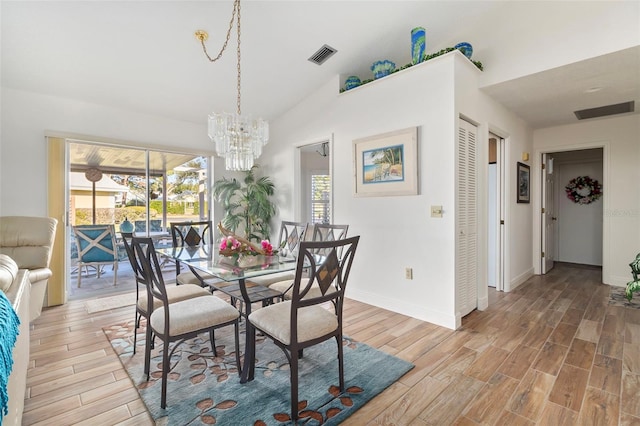 dining room with lofted ceiling, a wealth of natural light, and a chandelier