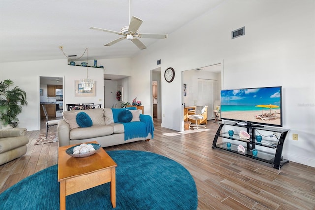 living room with vaulted ceiling, ceiling fan, and hardwood / wood-style floors