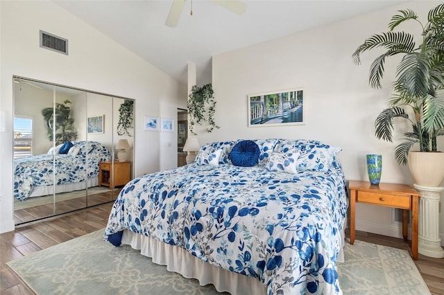 bedroom featuring hardwood / wood-style flooring, vaulted ceiling, ceiling fan, and a closet