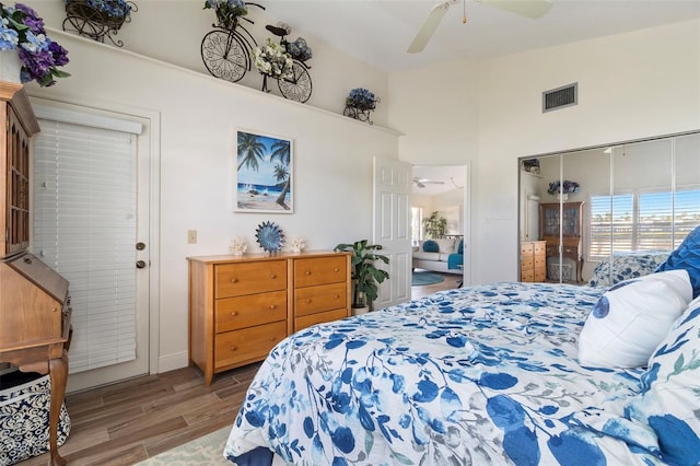 bedroom featuring hardwood / wood-style flooring, ceiling fan, and high vaulted ceiling