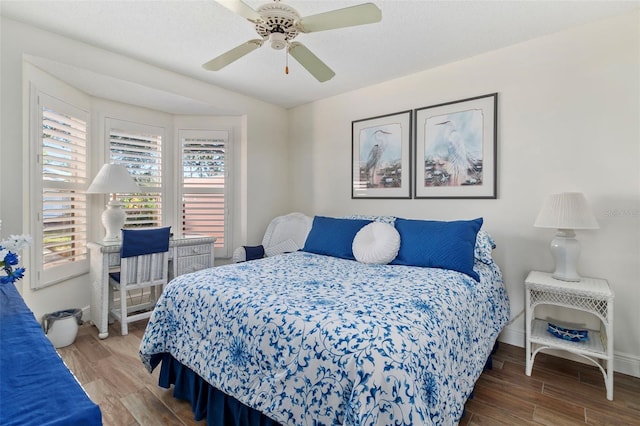 bedroom with ceiling fan and hardwood / wood-style floors