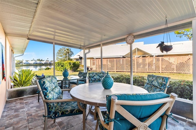 sunroom / solarium with a water view