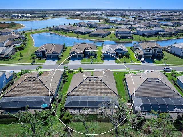 birds eye view of property with a water view and a residential view