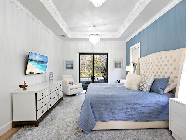 bedroom featuring a notable chandelier, visible vents, access to exterior, a tray ceiling, and crown molding