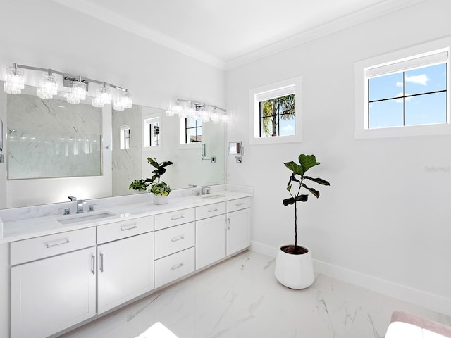 full bath with ornamental molding, marble finish floor, a sink, and baseboards