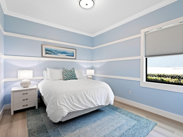 bedroom with crown molding and light hardwood / wood-style floors